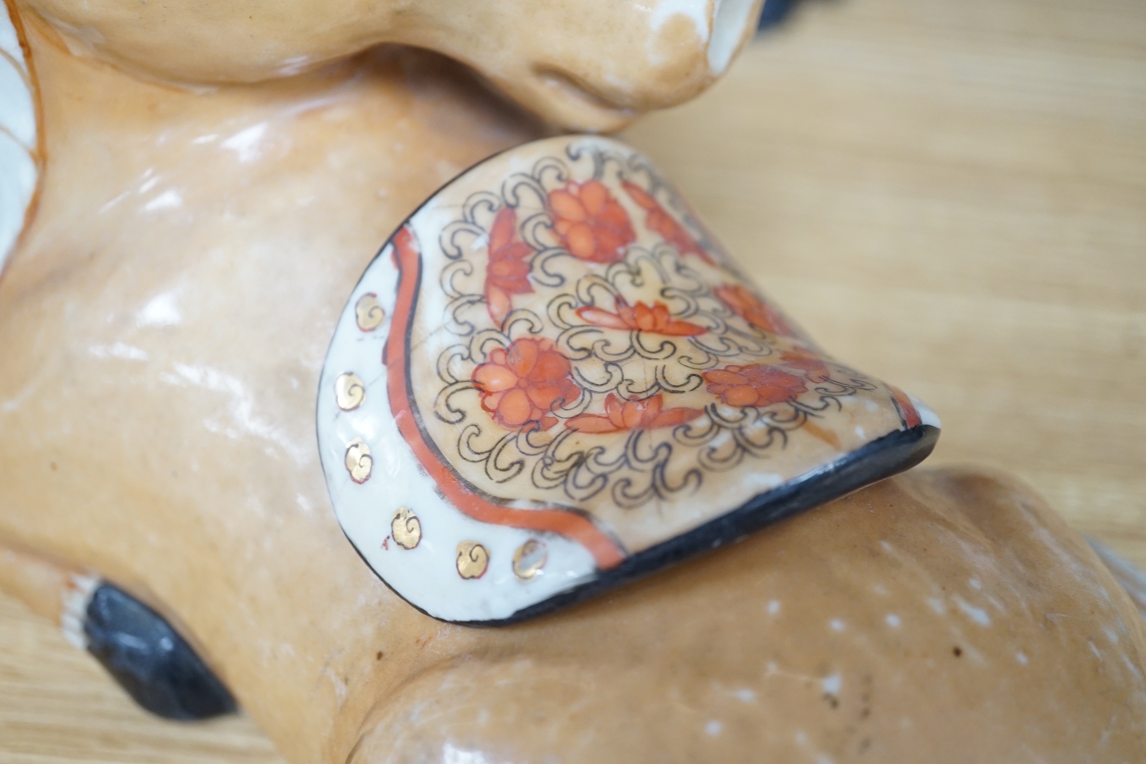 A pair of Chinese ceramic seated horses, 18cm high
